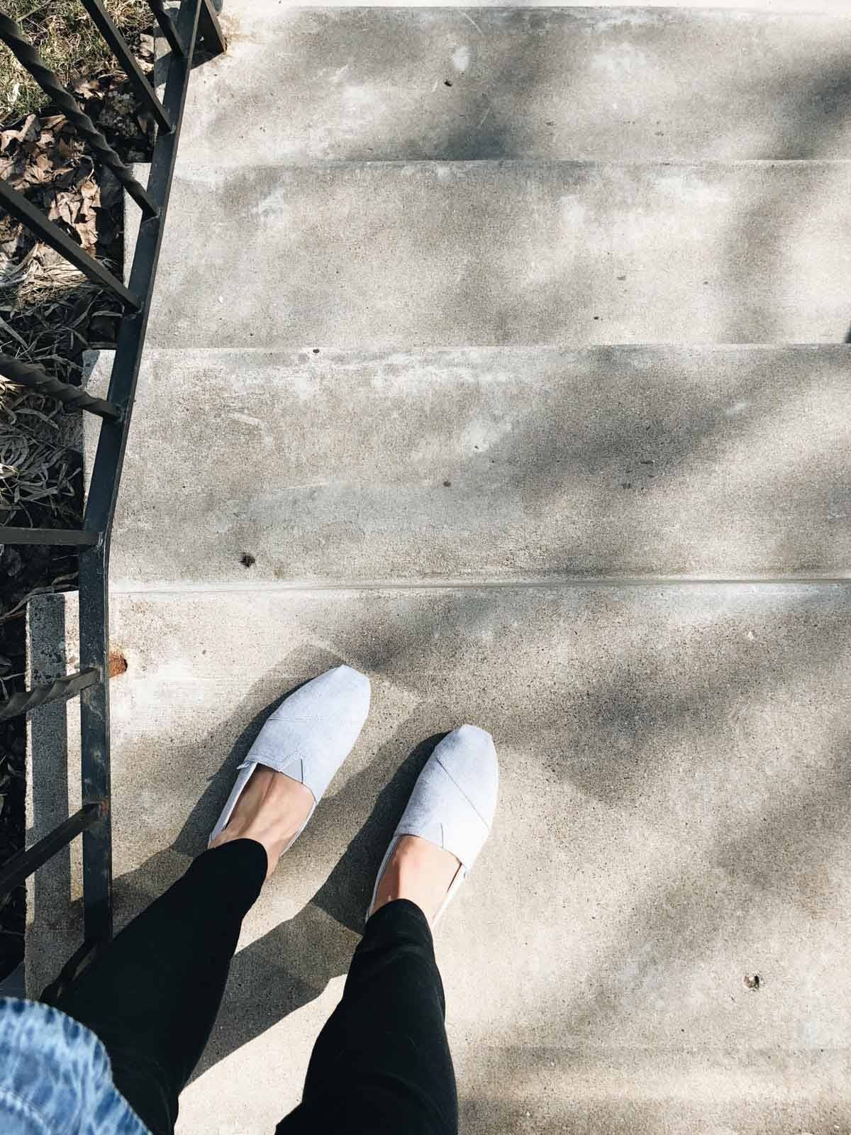 Standing on front step with shoes.