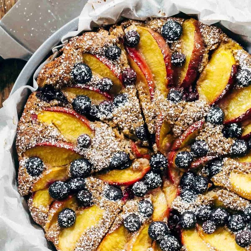 A dessert baked with fruit and powdered sugar on top.