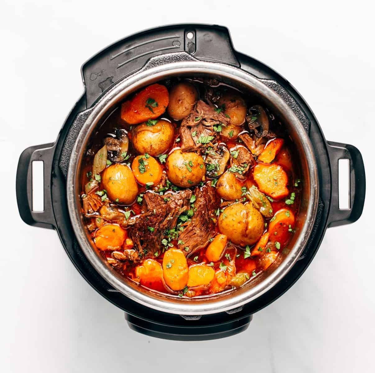 Stewed potatoes, meat, mushrooms, spices, and onions in an instant pot