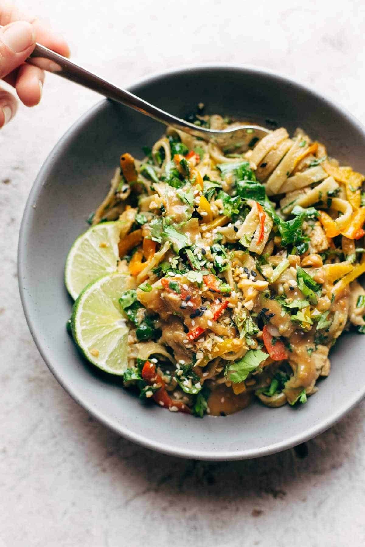 Thai Noodle Salad with Peanut Lime Dressing in a bowl with a fork