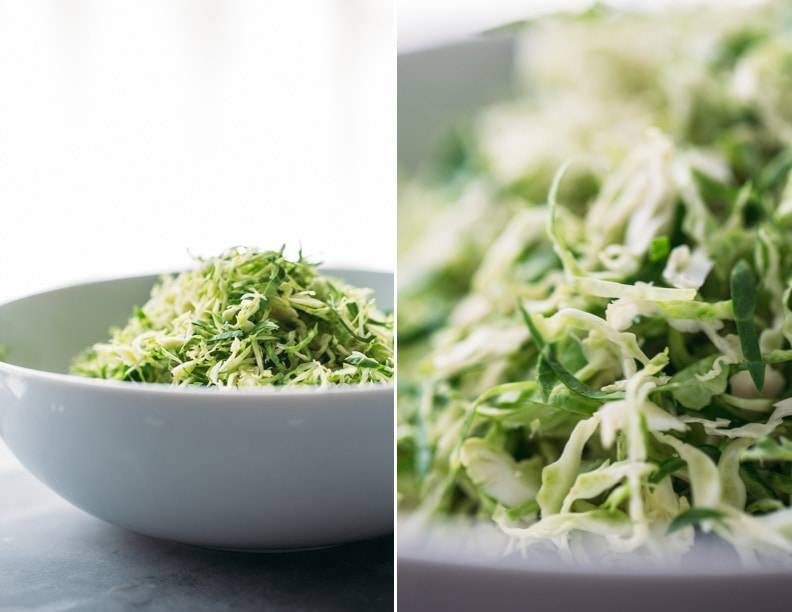 Shaved brussels sprouts in a white bowl.
